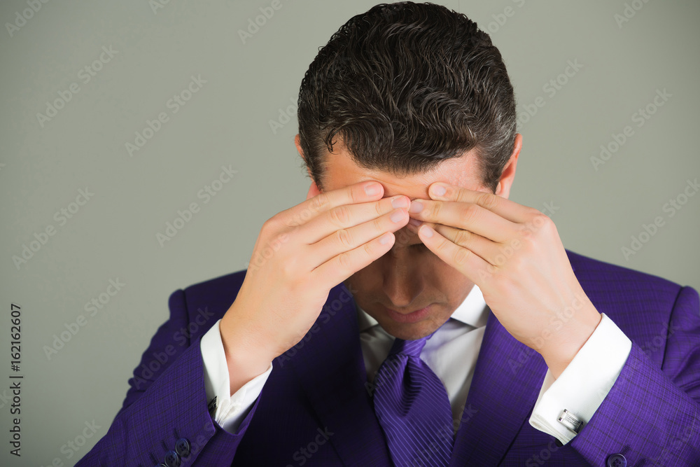 businessman feeling headache with stylish hair in violet suit