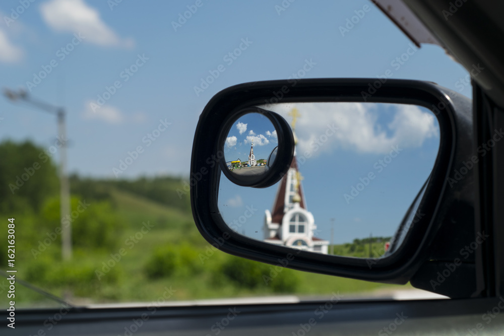 Church in the mirror of a car