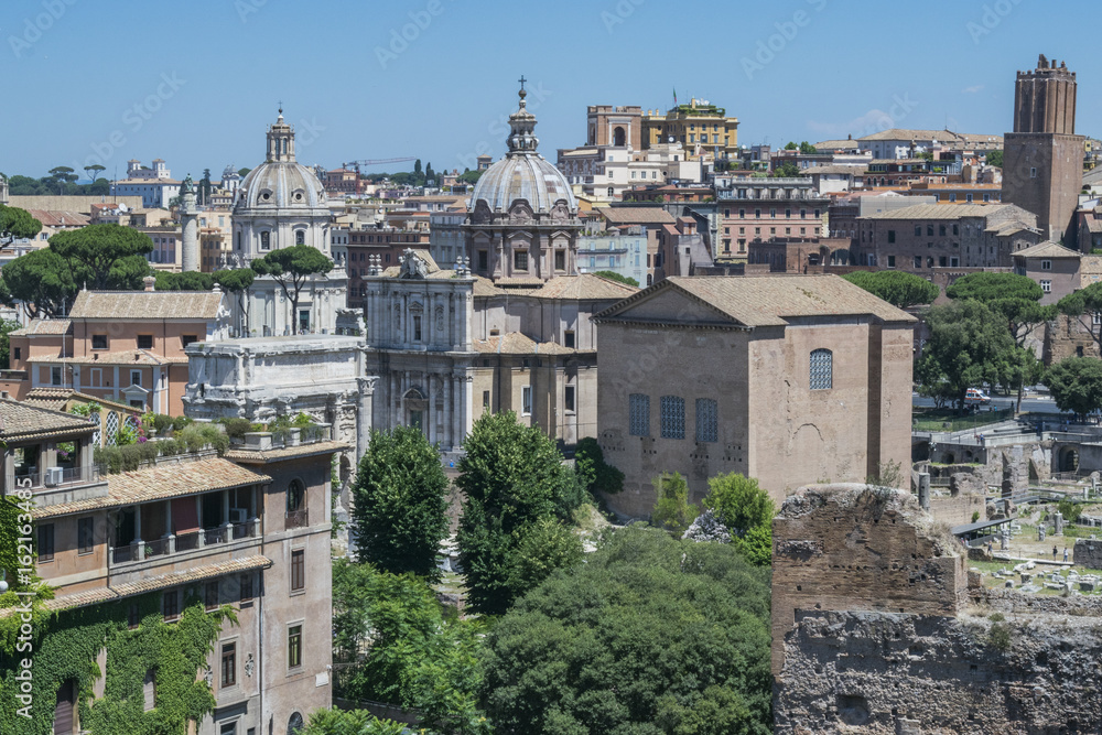 Skyline of Rome downtown in daytime in June as seen from Forum sightseeing point, Rome, Italy.