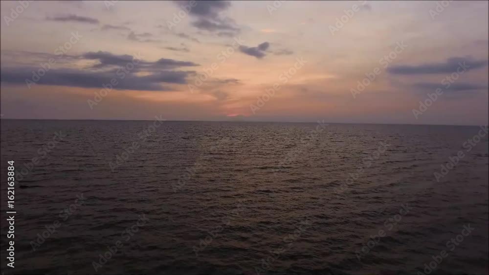 Purple and yellow color evening sky over the sea with gentle waves, Gulf of Thailand Purple and yellow color evening sky over the sea with gentle waves, Gulf of Thailand