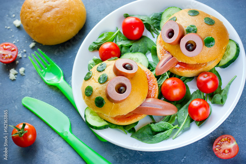 Cute frog shaped hamburger on a plate with fresh vegetables