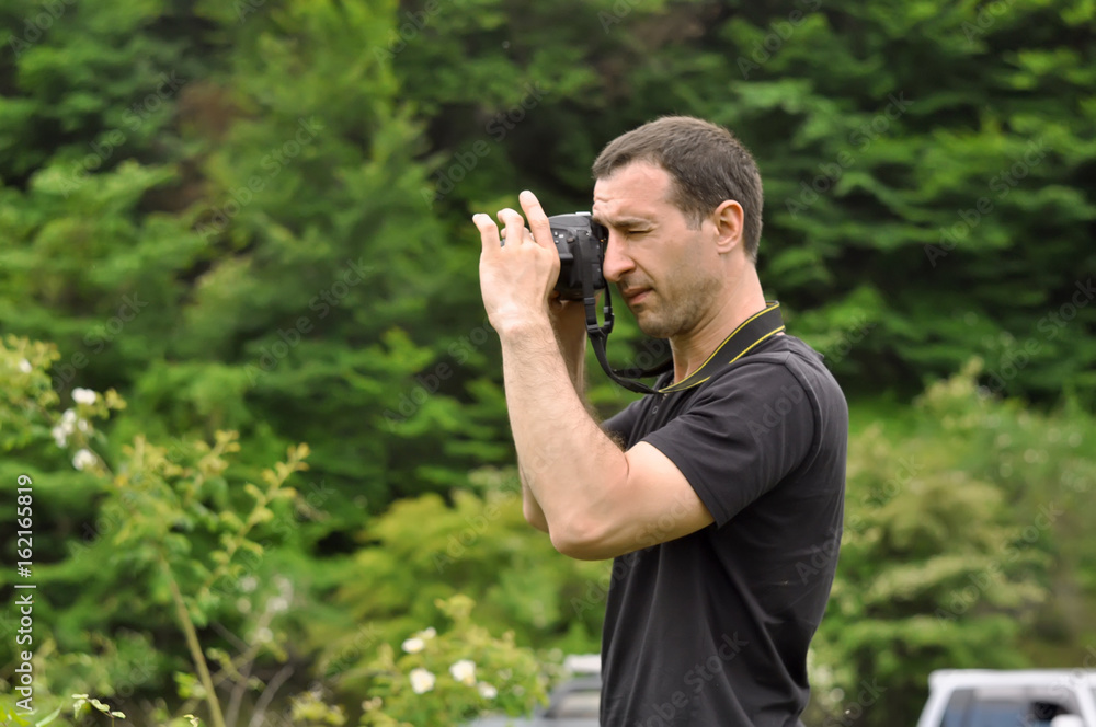 a man taking photo with camera at mountains a man taking photo with camera at mountains