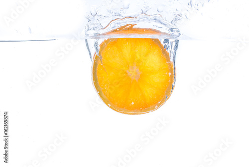 orange slice in water splash on white  background