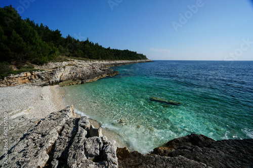 Beach with crystal-clear water in Premantura Pensinsula, Croatia photo