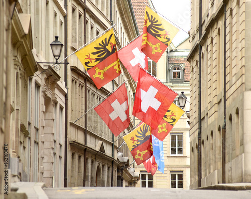 Swiss Flag and Flag of Geneva on the facade building in Geneva, Switzerland photo