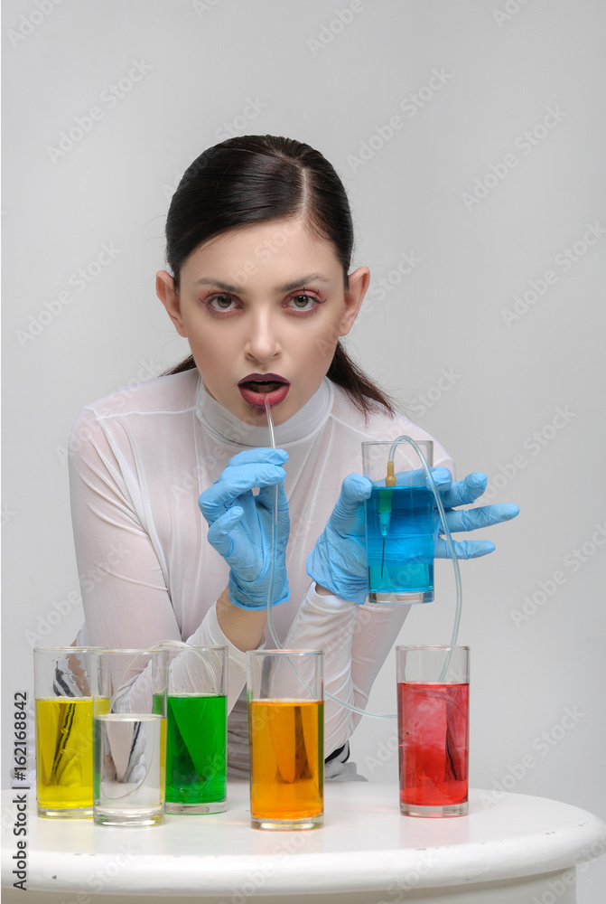 Fashion portrait of a girl who drinks unnatural fluids Fashion portrait of a girl who drinks unnatural fluids