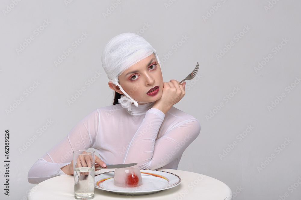 Fashion portrait of a sick girl with a bandage on her head Fashion portrait of a sick girl with a bandage on her head