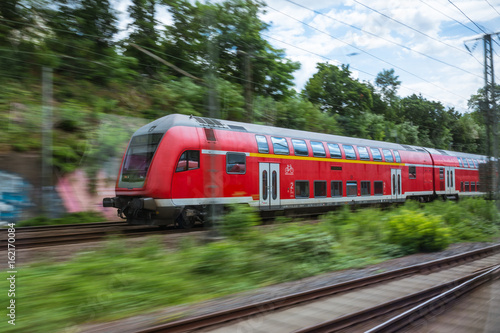 Red European Train Public Transport Motion Blur through Outdoors Area Traveling