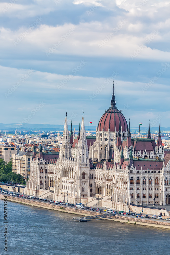 Fototapeta premium Travel and european tourism concept. Parliament and riverside in Budapest Hungary during summer sunny day with blue sky and clouds