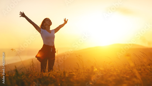 Happy woman   on the sunset in nature in summer with open hands
 #162170834