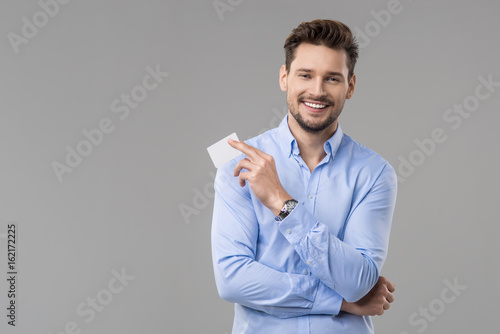 Handsome man in blue shirt  with white card photo