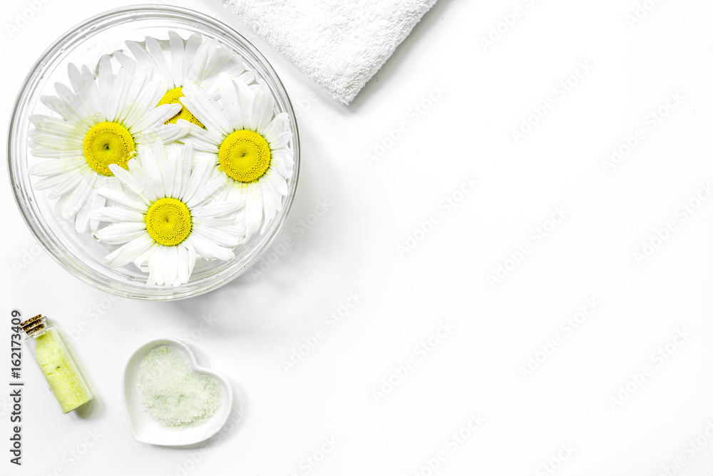 natural cosmetics design with chamomiles for manicure on white table background top view space for text natural cosmetics design with chamomiles for manicure on white table background top view space for text
