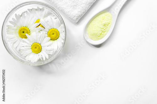 Spa composition with salt, chamomile and towel copyspase top view white background