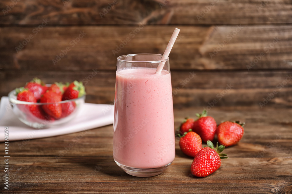 Delicious yogurt smoothie with strawberry on wooden background Delicious yogurt smoothie with strawberry on wooden background