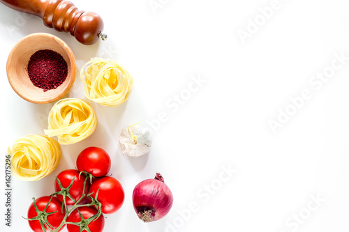 Preparing for cooking italian pasta white background top view copyspace