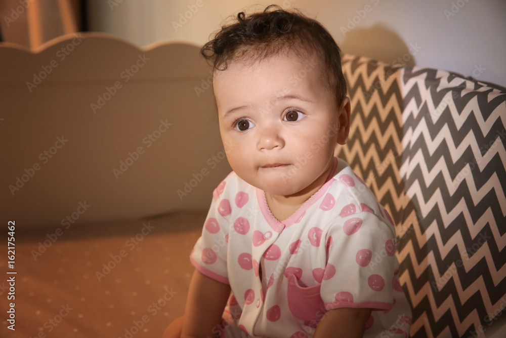 Cute little baby sitting in cradle at home. Sleep disorders concept Cute little baby sitting in cradle at home. Sleep disorders concept