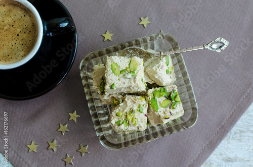 Halva pistachio and cup of coffee photo