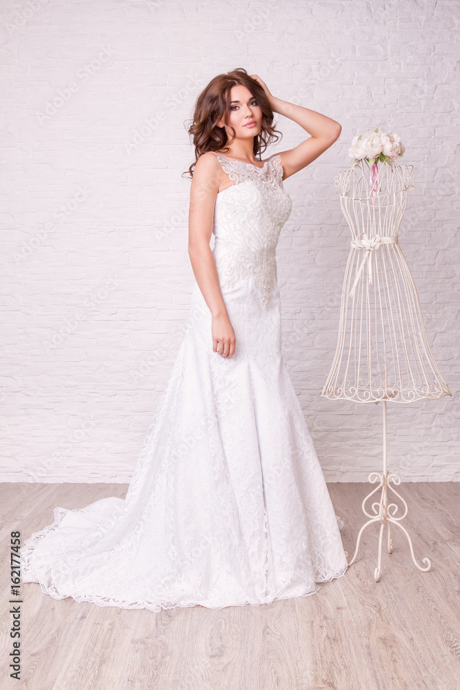 Beautiful woman in wedding dress pose in studio Beautiful woman in wedding dress pose in studio