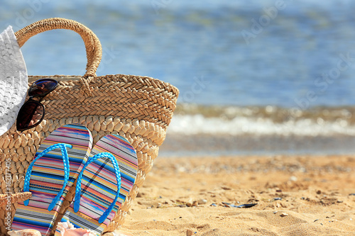 Beach accessories on sand at sea shore. Vacation concept