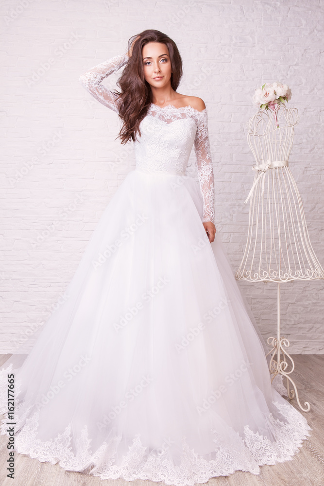 Beautiful woman in wedding dress pose in studio Beautiful woman in wedding dress pose in studio