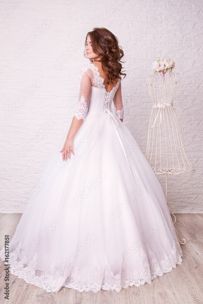Beautiful woman in wedding dress pose in studio Beautiful woman in wedding dress pose in studio