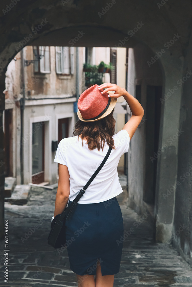 Woman walks on the historical european streets of old town. Woman walks on the historical european streets of old town.