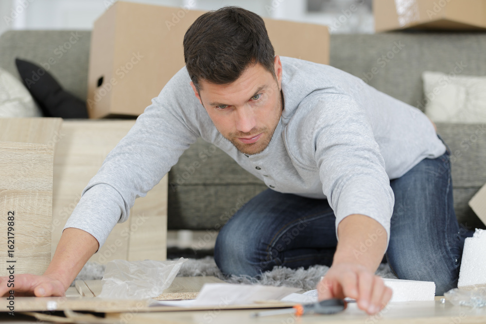 man assembling furniture man assembling furniture