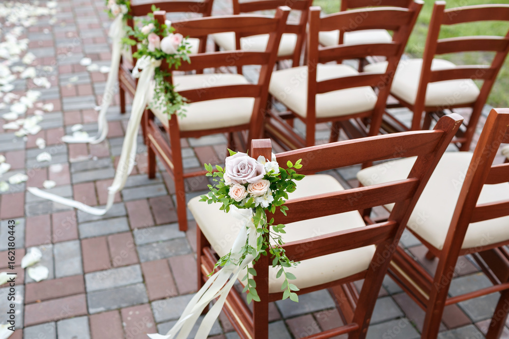 wedding decorated wooden chairs with flowers