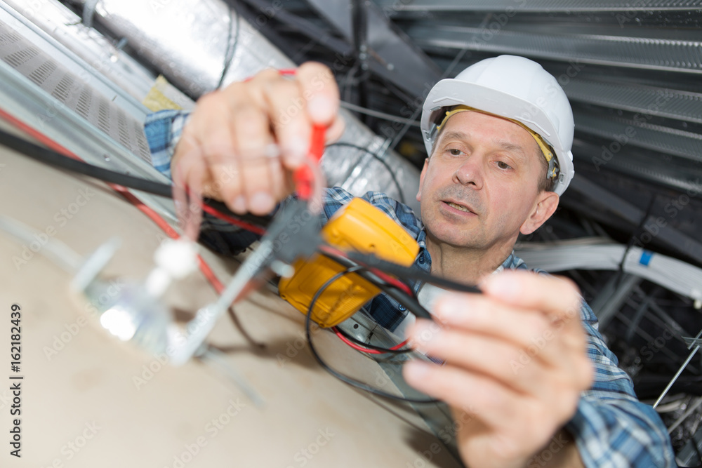 electrician repairing wiring inside office ceiling electrician repairing wiring inside office ceiling