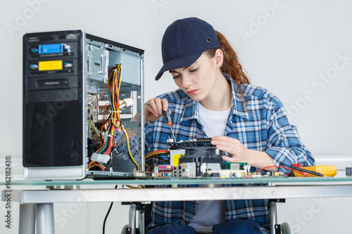 Wallpaper Mural young pretty woman repairing computer Torontodigital.ca
