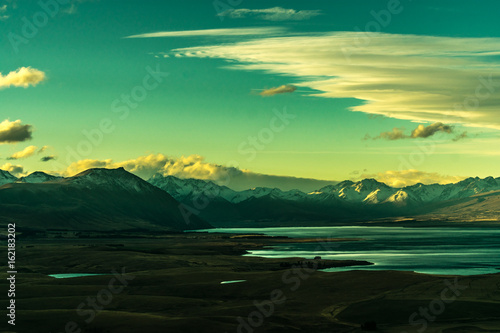 View of the mountains, lake and valey in a sunny day from mount john/ lake tekapo