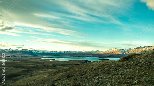 View of the mountains, lake and valey in a sunny day from mount john/ lake tekapo