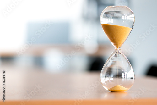Sand clock, business time management concept photo