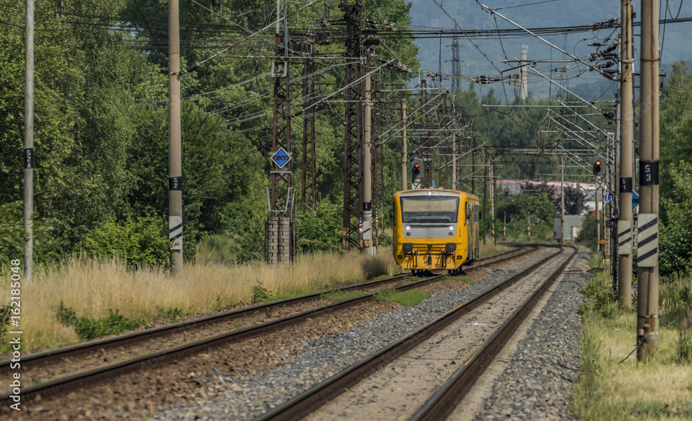 Fototapeta premium Yellow and orange train near Kostov station