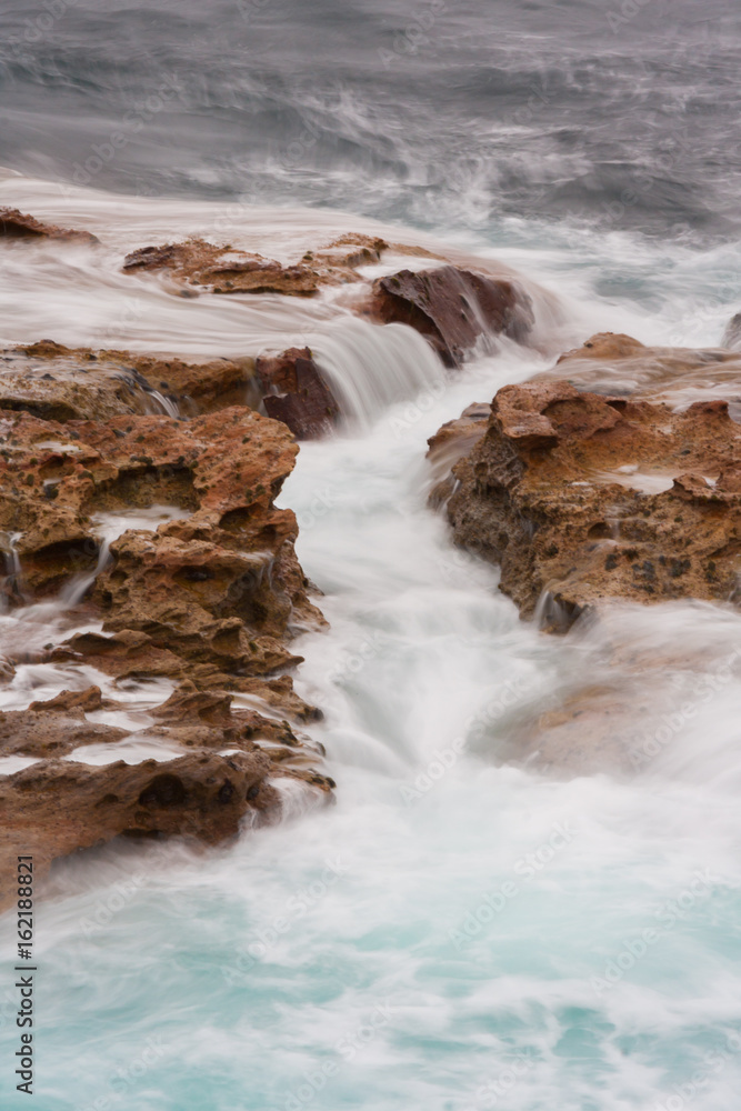 Strong wave splashing through the rocks at Coogee beach, Australia