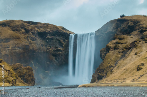 Long exposure shot of empty Skogarfoss, Southern Iceland in a cloudy day. Soft focus due to long exposure shot