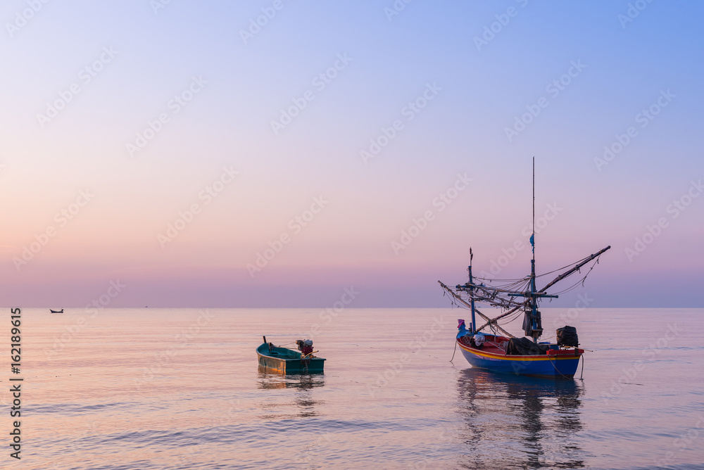 Sunrise at the Sea with fisher boats and cloudy sky Sunrise at the Sea with fisher boats and cloudy sky