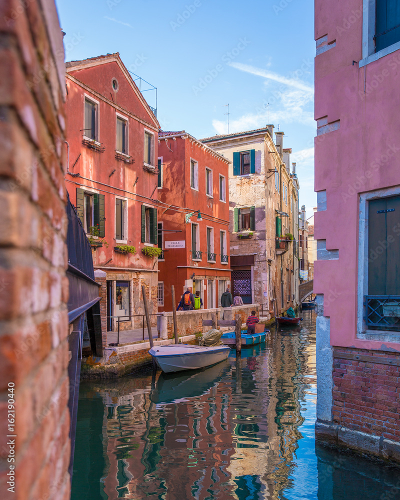 Colorful Sunlit Venetian Buildings Along Canal