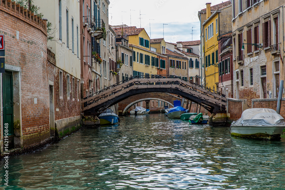 Venetian canal view with bridge and colorful buildings