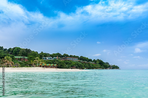 The view of resort and tropical beach at lipe island thailand with white sand, turquoise ocean water and blue sky.