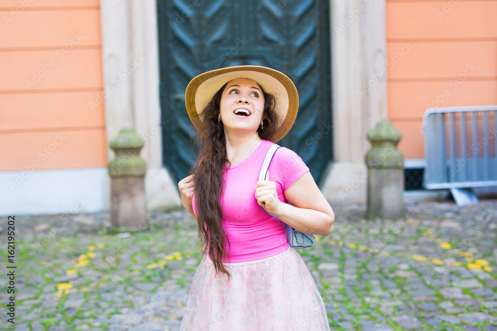 fashion, happiness and lifestyle concept - beautiful woman in hat enjoying summer outdoors