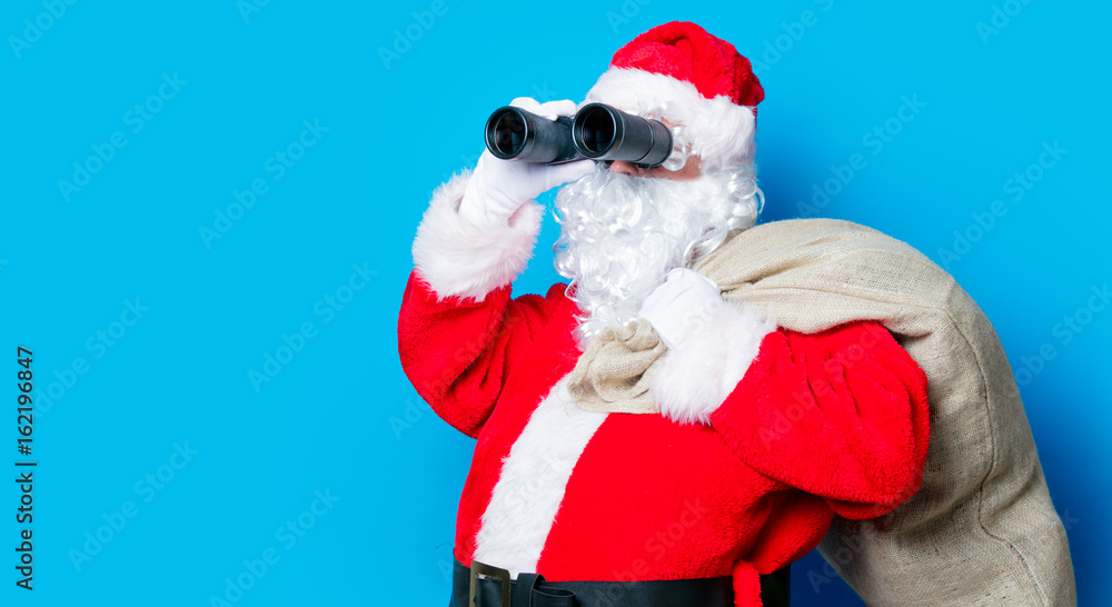 Funny Santa Claus have a fun with binoculars Funny Santa Claus have a fun with binoculars