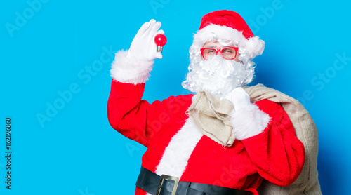Funny Santa Claus have a fun with light bulb