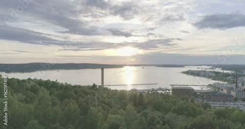 Evening aerial view of Radio communication tower of top of hill in Lahti, Finland, sideways movement