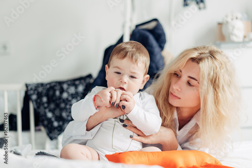 mother playing with her baby in the bedroom