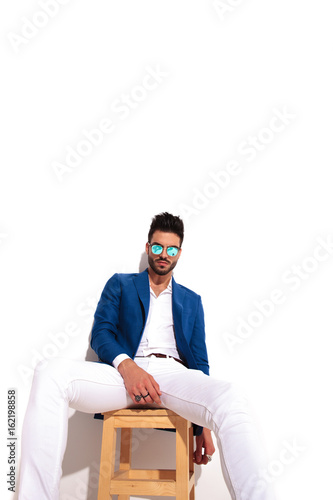 fashion model is resting on chair with copyspace above photo