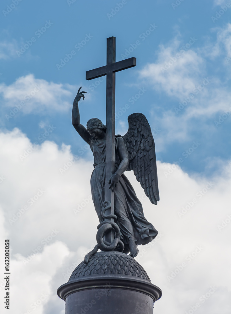 Angel with cross on the Alexander column at the background daytime blue sky , Saint Petersburg, Russia
