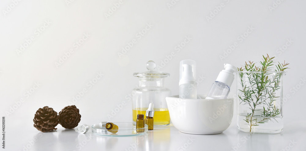 Cosmetic bottle containers with green herbal leaves and scientific glassware, Blank label package for branding mock-up, Research and develop natural organic beauty skincare product concept. Cosmetic bottle containers with green herbal leaves and scientific glassware, Blank label package for branding mock-up, Research and develop natural organic beauty skincare product concept.