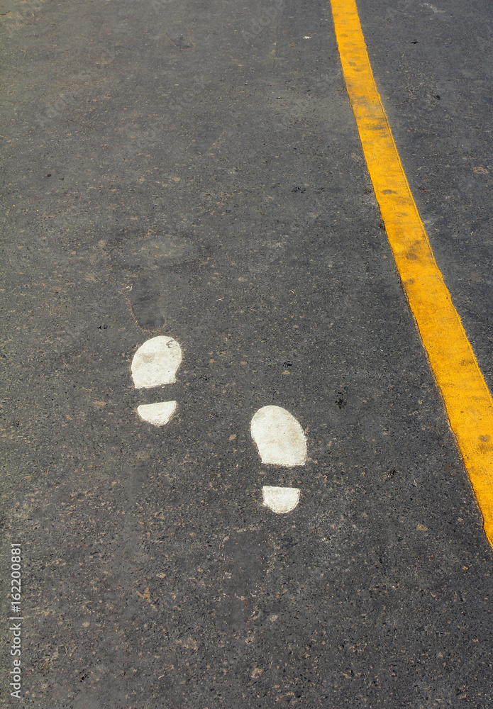Walking Track With Yellow Footprints Painted On Road. Walking Track With Yellow Footprints Painted On Road.
