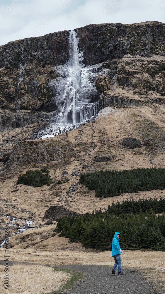 Advature man human scale with majestic waterfall mountain size. Wonderful world of nature